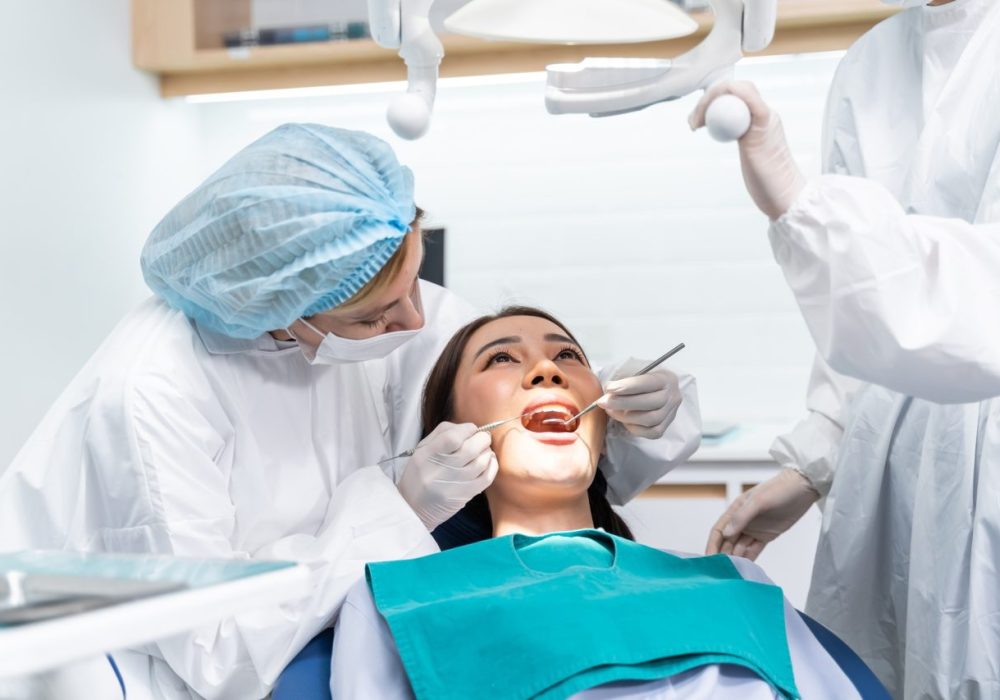 caucasian-dentist-examine-tooth-for-young-girl-at-dental-health-clinic-.jpg